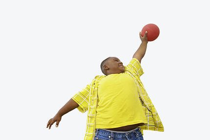 Boy holding ball in air