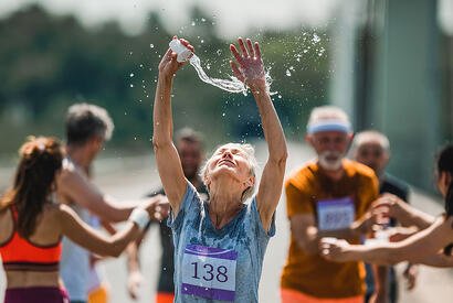 Woman pouring water on head during race
