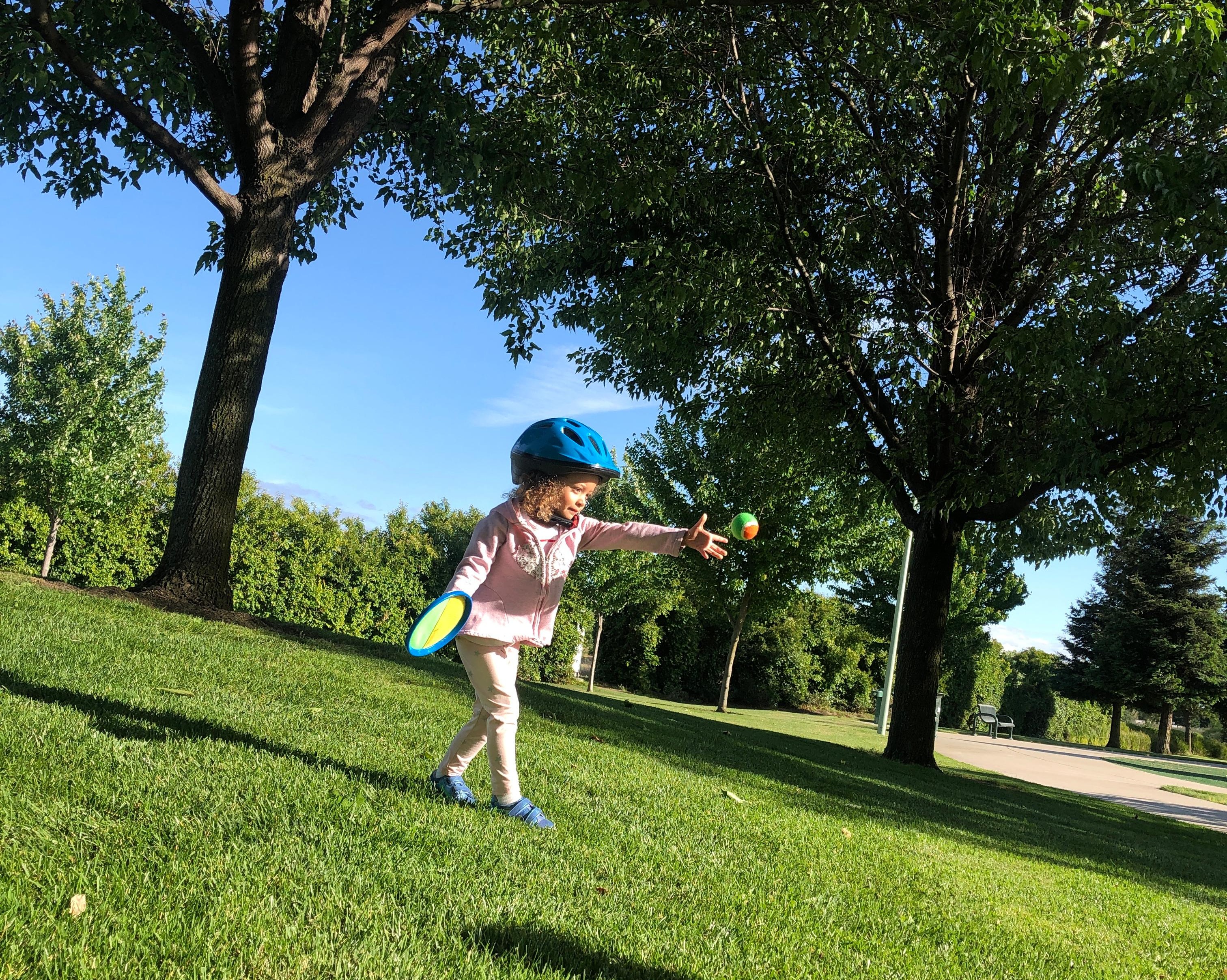 a child throwing a ball underhand